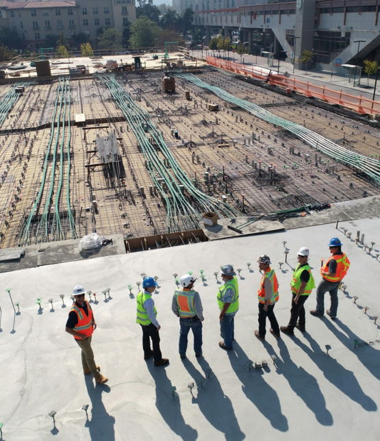 seven-construction-workers-standing-on-white-field.jpg seven construction workers standing on white field